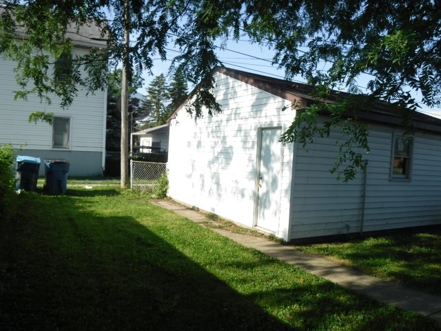 513 Pulaski Road Calumet City, IL 60409 - Photo 18 of 18 a view of backyard with potted plants and a large tree