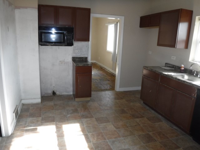513 Pulaski Road Calumet City, IL 60409 - Photo 6 of 18 a living room with a couch and a flat screen tv