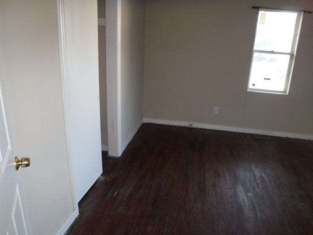 513 Pulaski Road Calumet City, IL 60409 - Photo 7 of 18 an empty room with wooden floor and windows