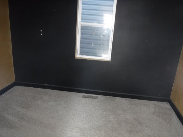 513 Pulaski Road Calumet City, IL 60409 - Photo 9 of 18 a view of an empty room with a window