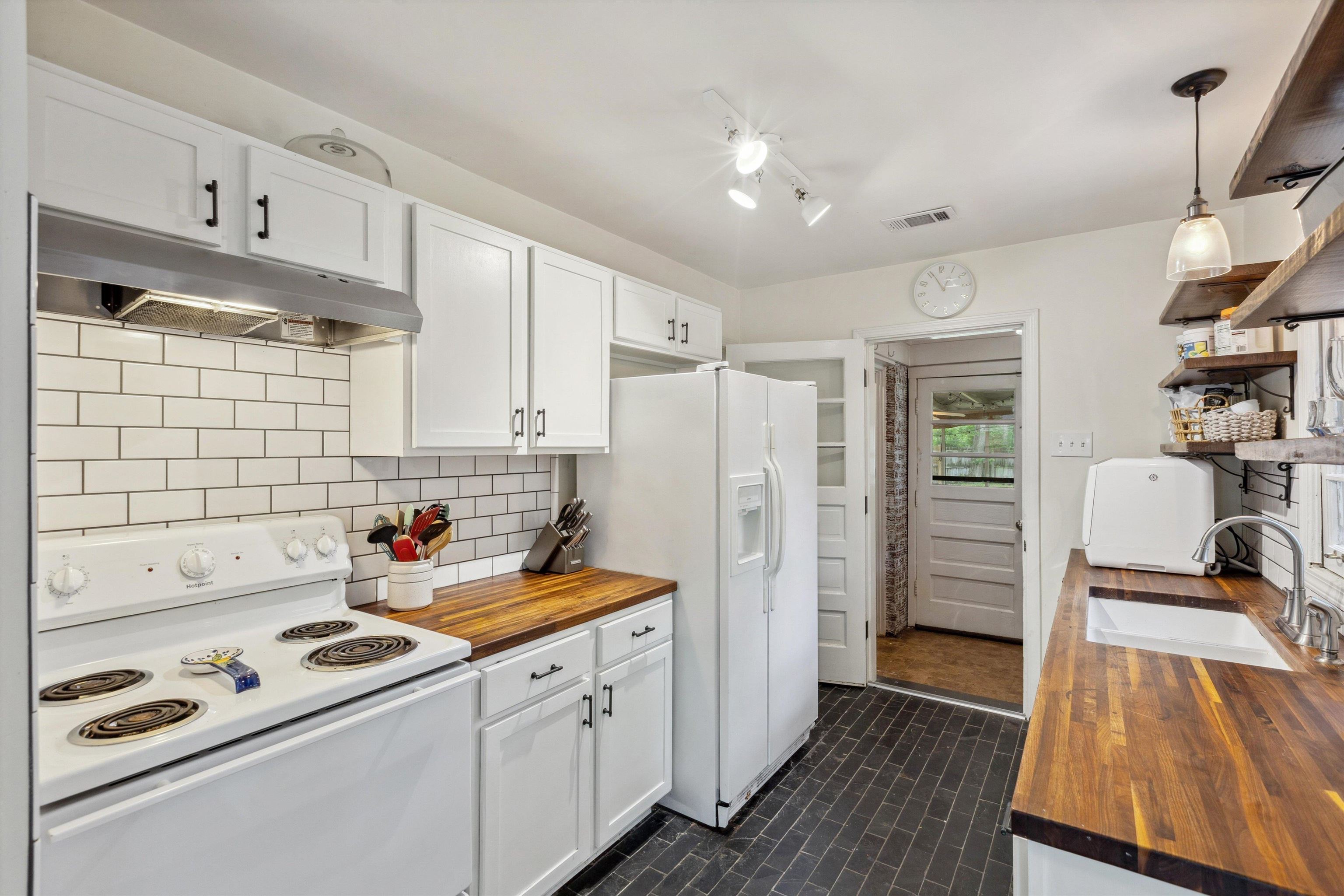 4514 Verne Road Memphis, TN 38117 - Photo 11 of 26 a kitchen with stainless steel appliances a refrigerator a sink and wooden floors