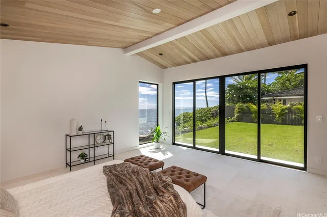 a bedroom with furniture and large windows