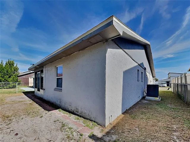 a backyard of a house with wooden fence and deck