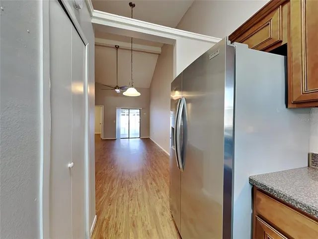 a view of a hallway with wooden floor