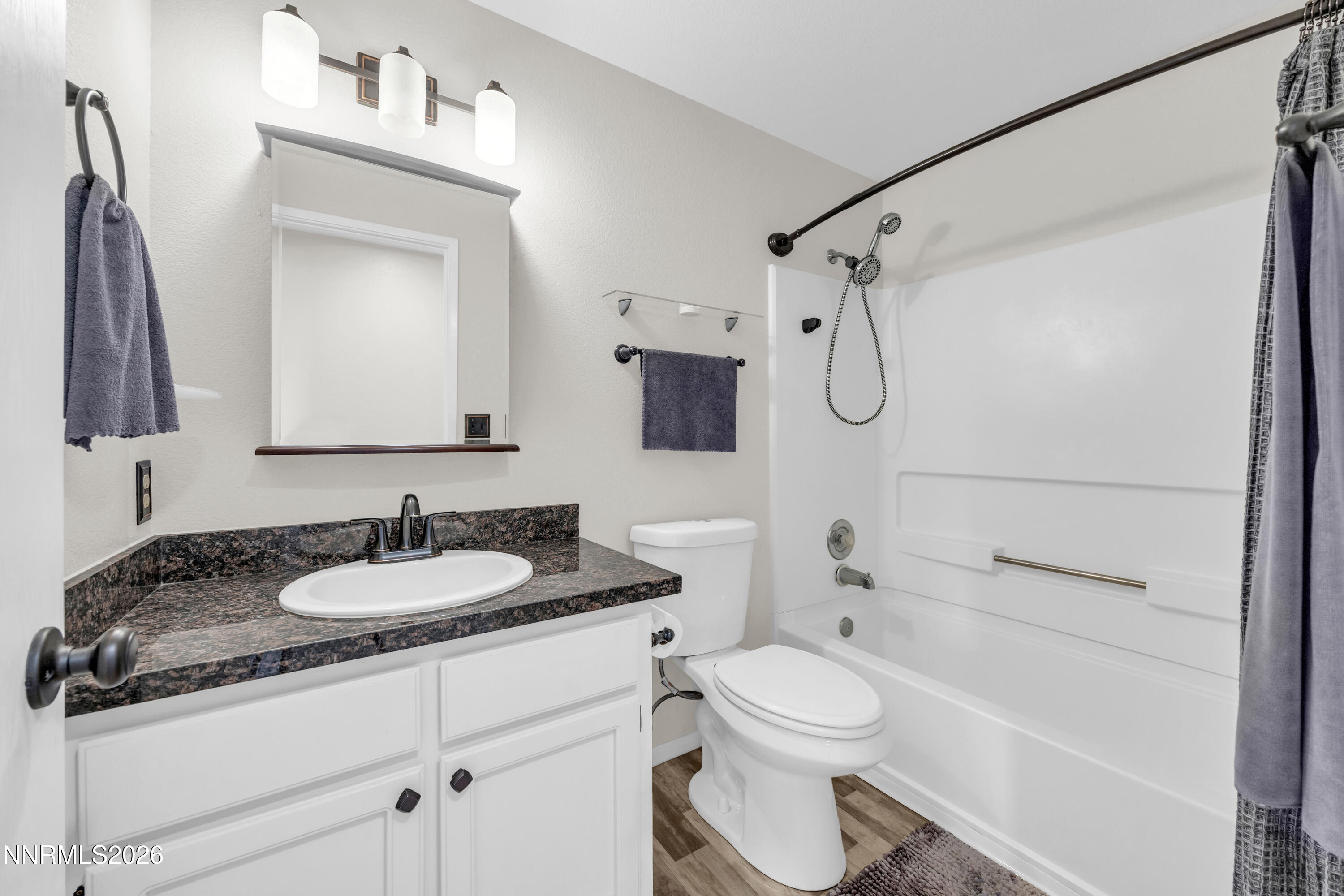 702 Ophir Court Dayton, NV 89403 - Photo 15 of 29 a bathroom with a granite countertop sink toilet mirror and shower