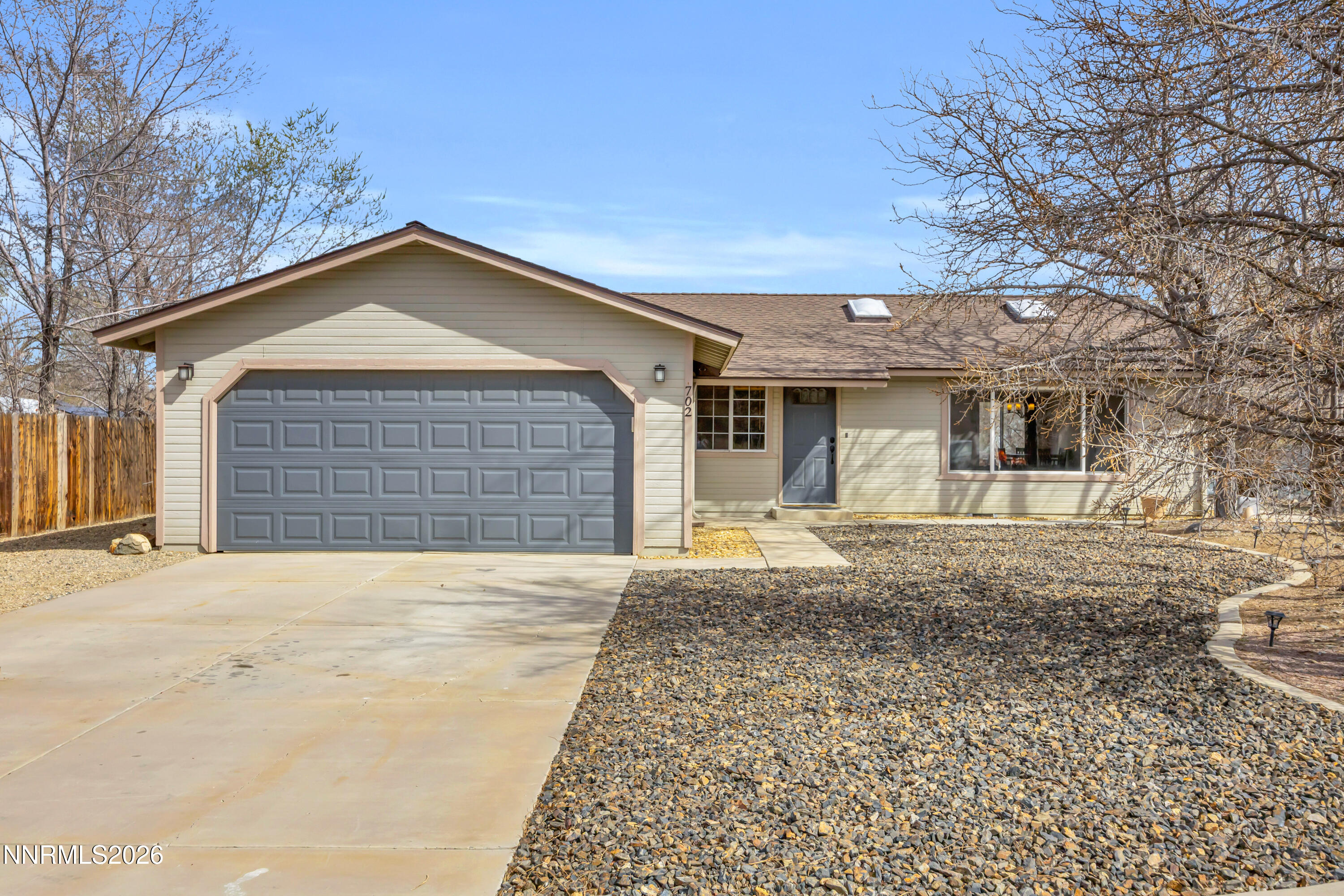 702 Ophir Court Dayton, NV 89403 - Photo 2 of 29 a front view of a house with a yard and garage