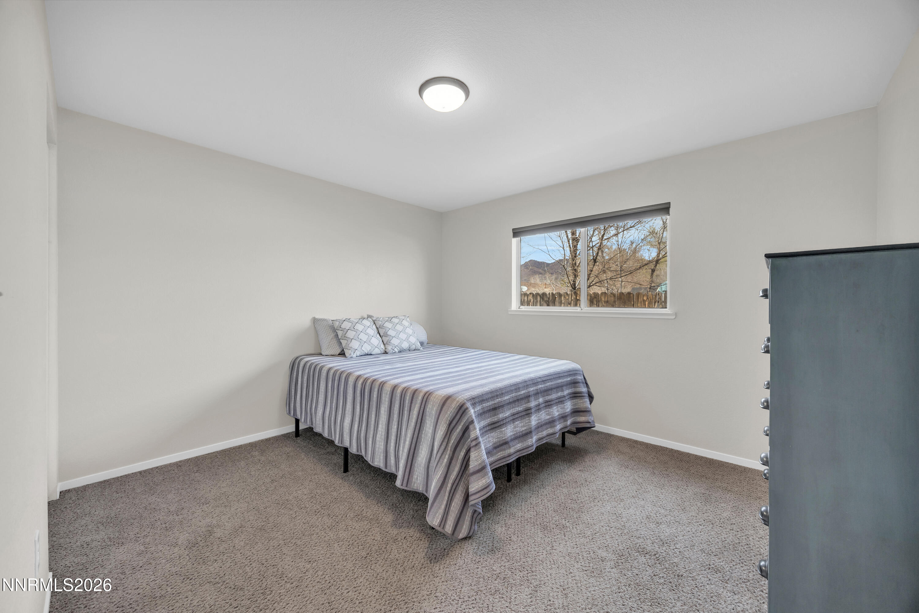 702 Ophir Court Dayton, NV 89403 - Photo 22 of 29 a spacious bedroom with a bed and a window