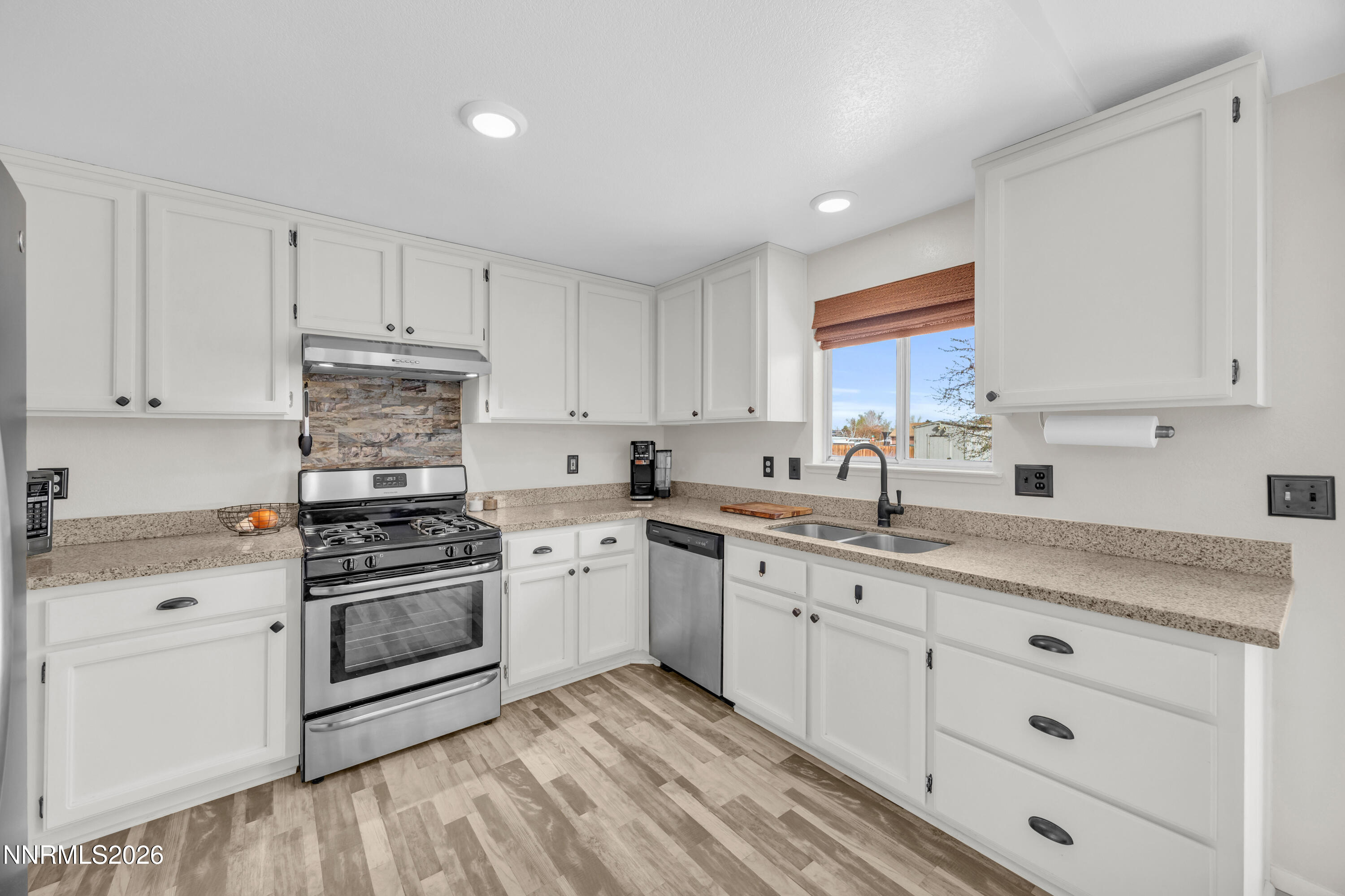 702 Ophir Court Dayton, NV 89403 - Photo 5 of 29 a kitchen with cabinets stainless steel appliances and a sink