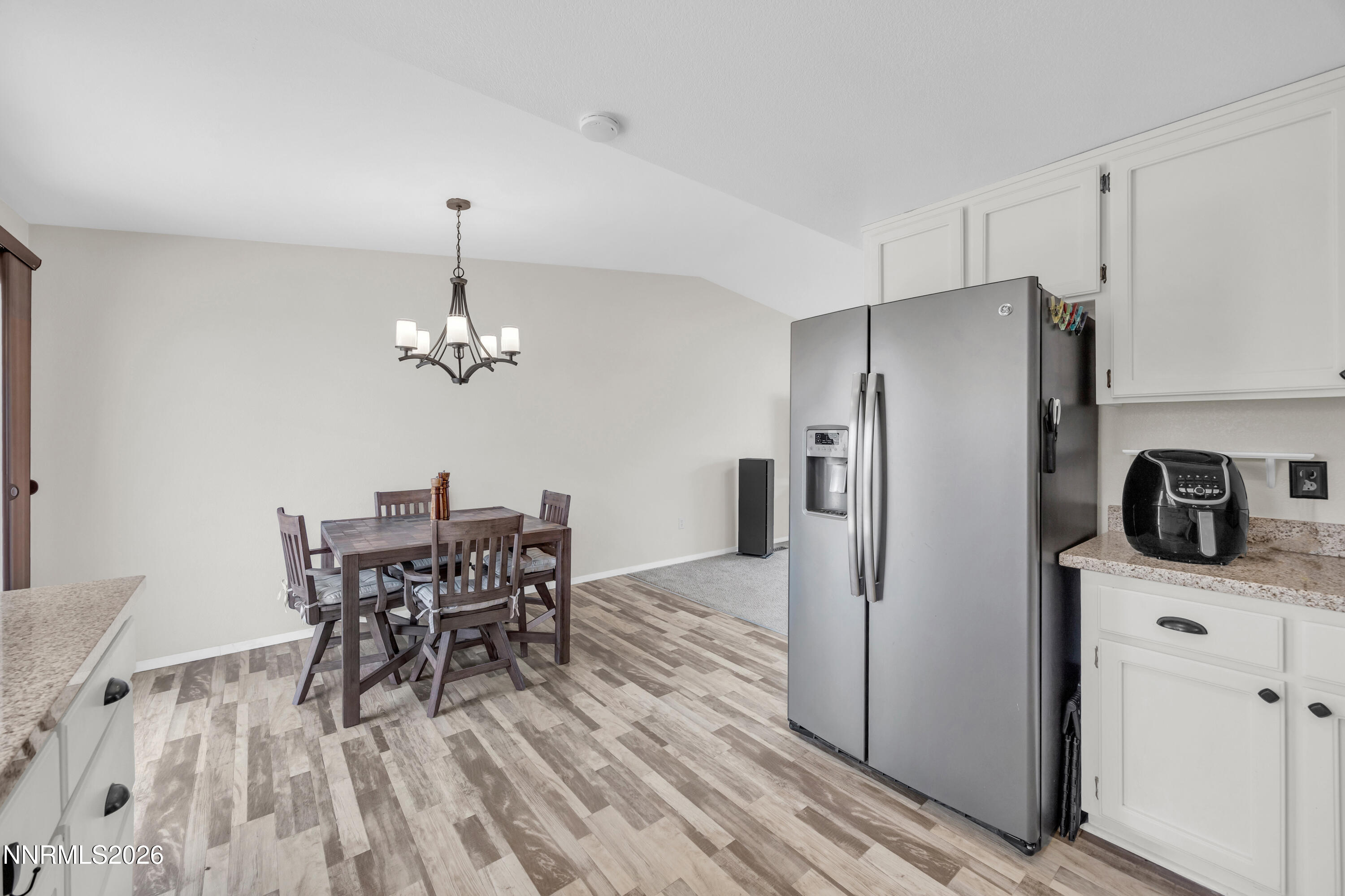 702 Ophir Court Dayton, NV 89403 - Photo 8 of 29 a view of a dining room with furniture a chandelier and wooden floor