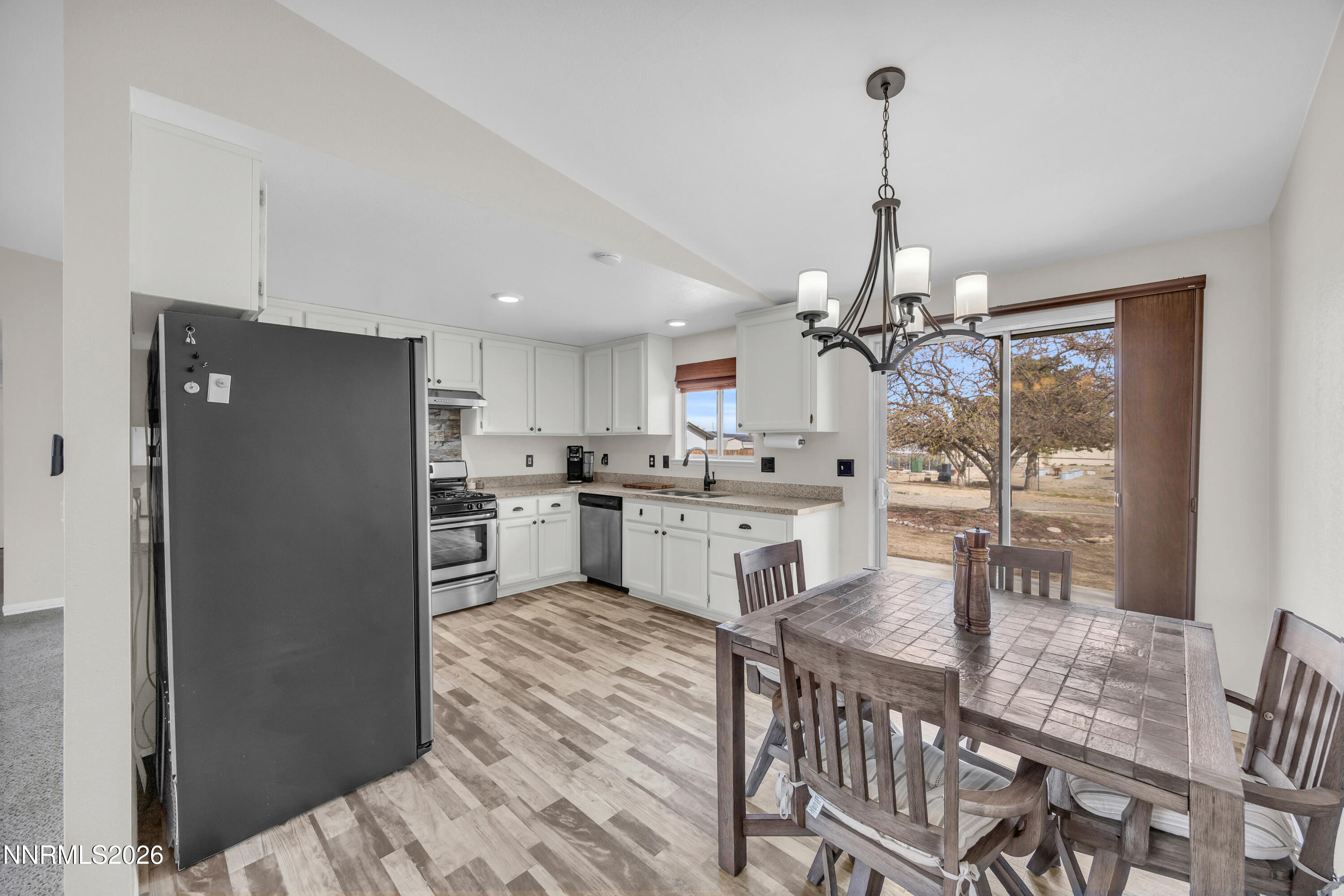 702 Ophir Court Dayton, NV 89403 - Photo 9 of 29 a kitchen with kitchen island a counter top space appliances and cabinets