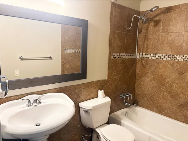 a bathroom with a sink mirror and shower