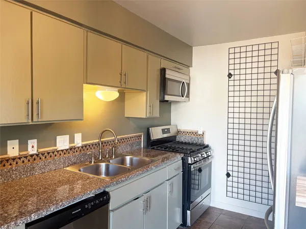 a kitchen with a sink cabinets and a window