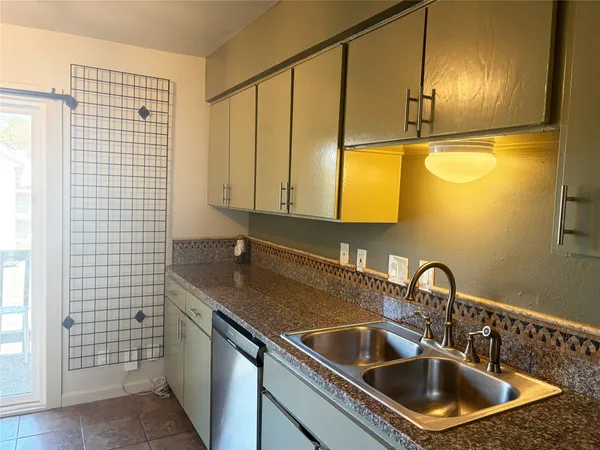 a kitchen with kitchen island a sink stove and microwave
