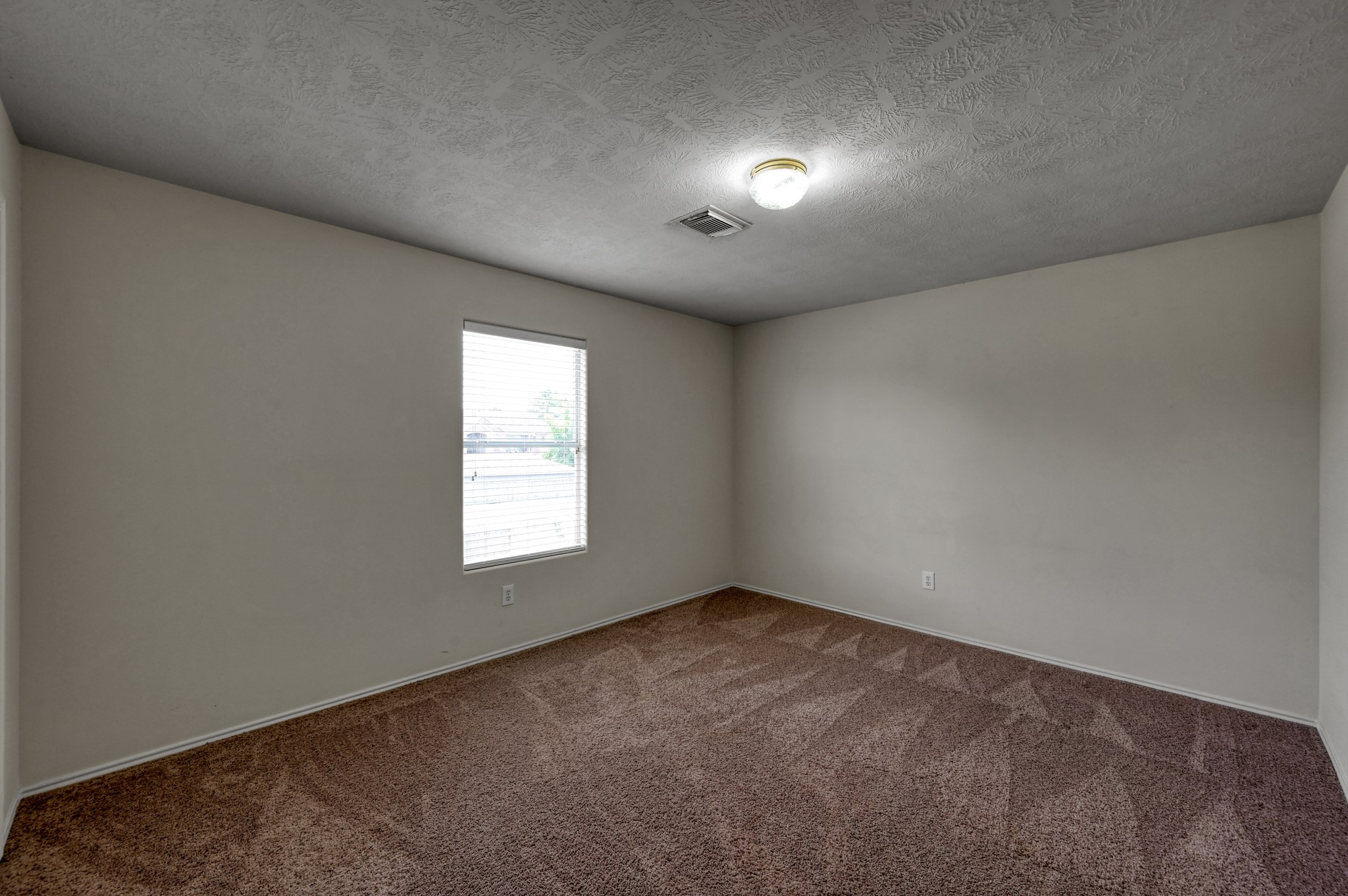 23919 Kingbriar Drive Spring, TX 77373 - Photo 28 of 33 A comfortable secondary bedroom with plush carpet, natural light, and a versatile layout that's perfect for family, guests, or a home office.