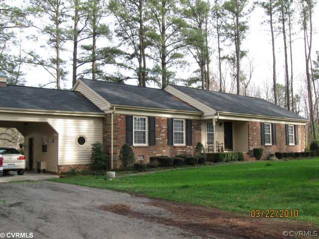 18611 Halifax Road Carson, VA 23830 - Photo 2 of 11 a front view of a house with a yard and trees