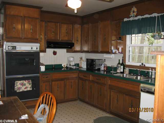 18611 Halifax Road Carson, VA 23830 - Photo 8 of 11 a kitchen with stainless steel appliances granite countertop a stove a sink dishwasher and cabinets