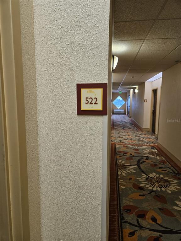 3000 Maingate Lane, Unit 522 Kissimmee, FL 34747 - Photo 5 of 14 a view of a hallway with staircase