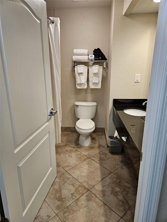 3000 Maingate Lane, Unit 522 Kissimmee, FL 34747 - Photo 6 of 14 a bathroom with a toilet and a shower