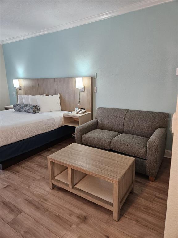 3000 Maingate Lane, Unit 522 Kissimmee, FL 34747 - Photo 8 of 14 a living room with furniture and wooden floor