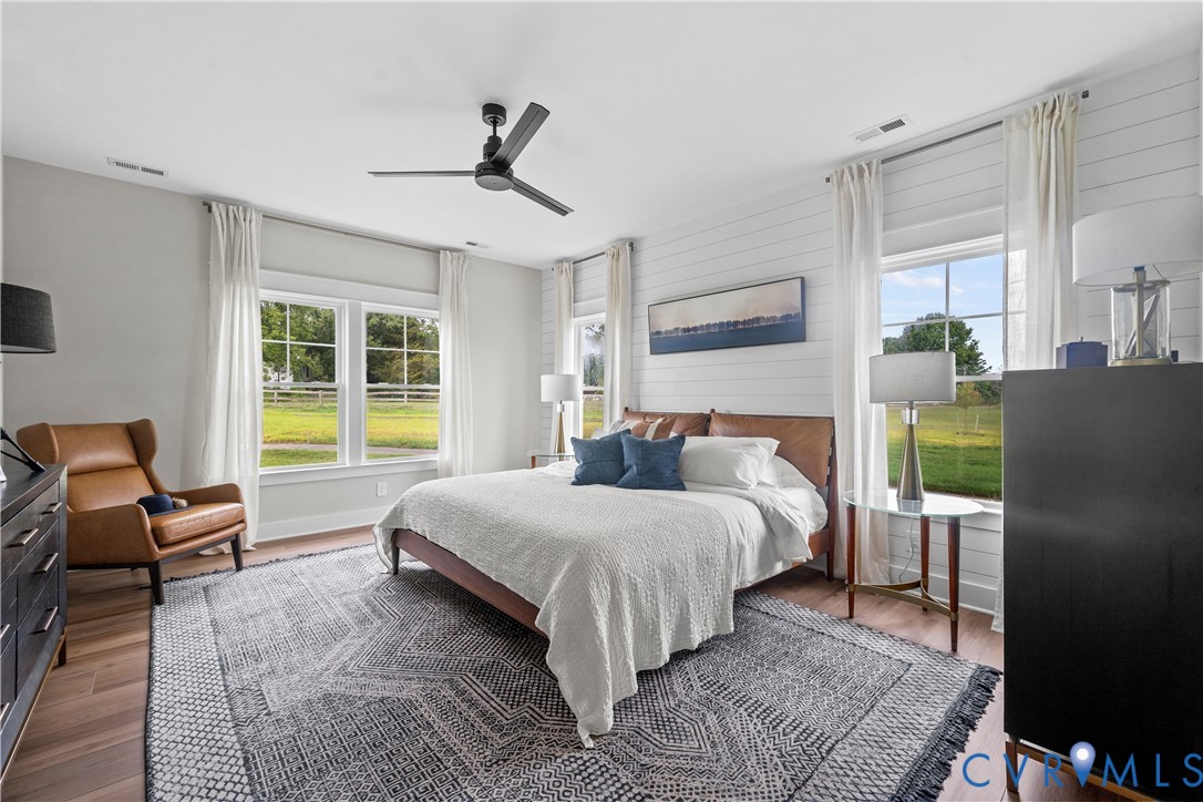 10422 Odette Est Lane, Unit S3 Mechanicsville, VA 23116 - Photo 22 of 27 a bedroom with a bed and wooden floor