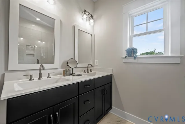 a bathroom with a double vanity sink and a mirror
