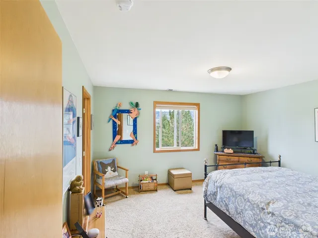 a bedroom with furniture and a window