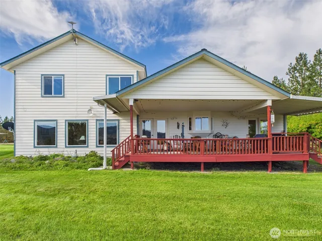 a view of a house with a yard and deck