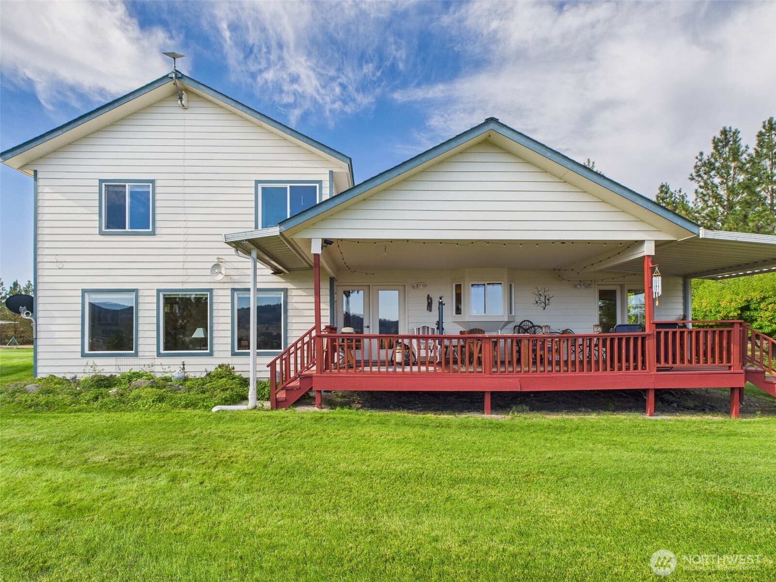 154 West Curlew Lake Road Republic, WA 99166 - Photo 18 of 28 a view of a house with a yard and deck
