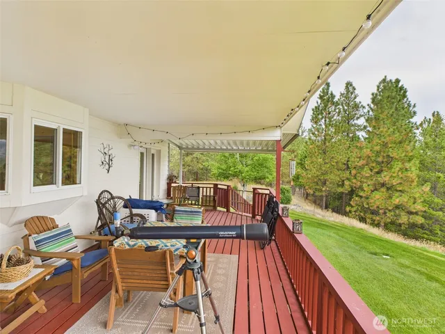 a balcony with wooden floor and outdoor seating