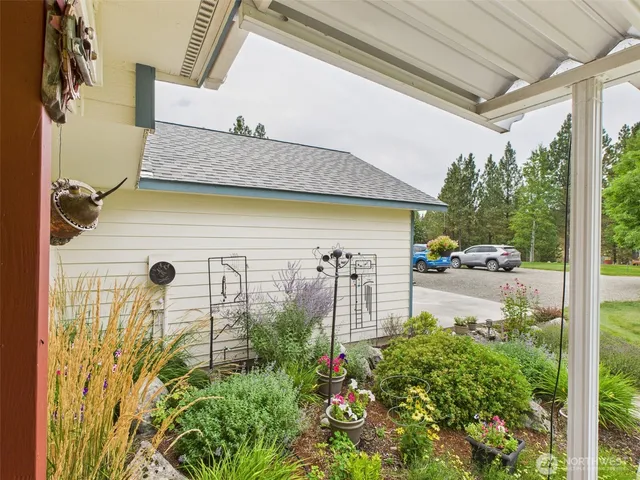 a view of a patio with table and chairs and potted plants
