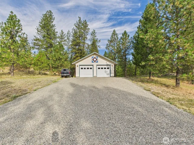 a view of under a large tree with wooden fence