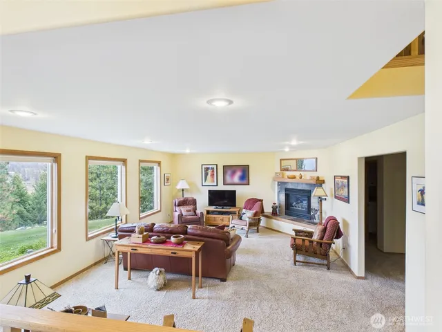 a living room with furniture a large window and a flat screen tv