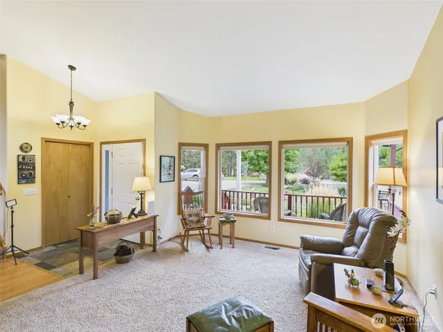 a living room with furniture and a floor to ceiling window