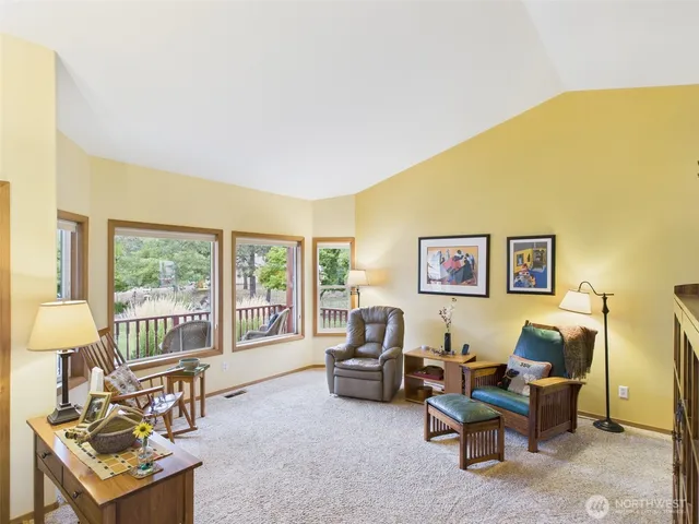 a living room with furniture and a floor to ceiling window