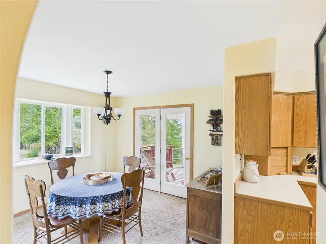 a view of a dining room with furniture window and outside view