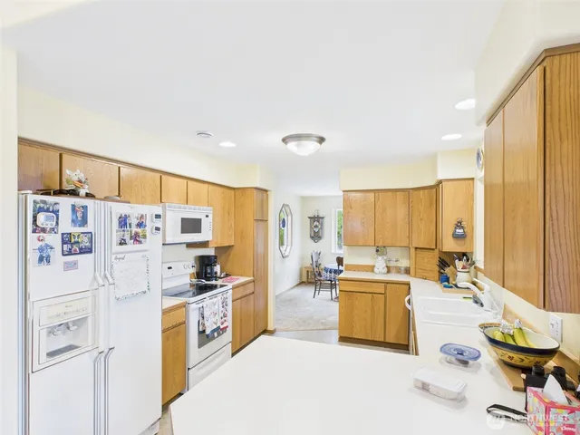 a kitchen with stainless steel appliances a refrigerator and a stove top oven