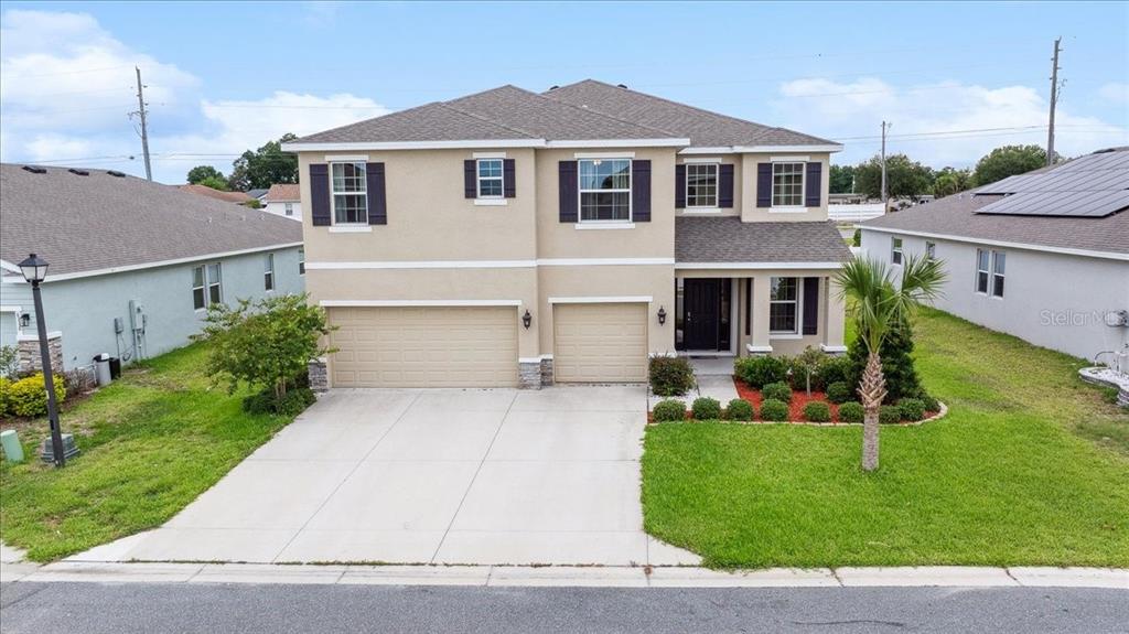 a front view of a house with a yard