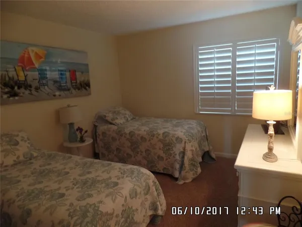 a bedroom with two beds and a window