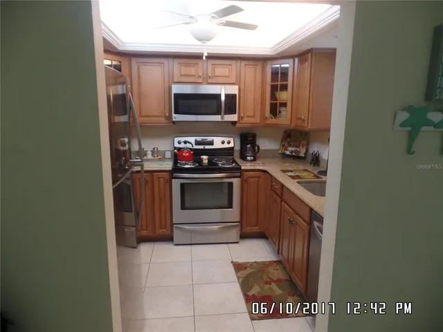 a kitchen with stainless steel appliances a stove and a microwave