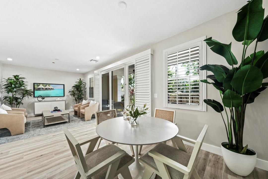 5520 Northeast Trieste Way Boca Raton, FL 33487 - Photo 10 of 57 a living room with furniture a potted plant and a large window