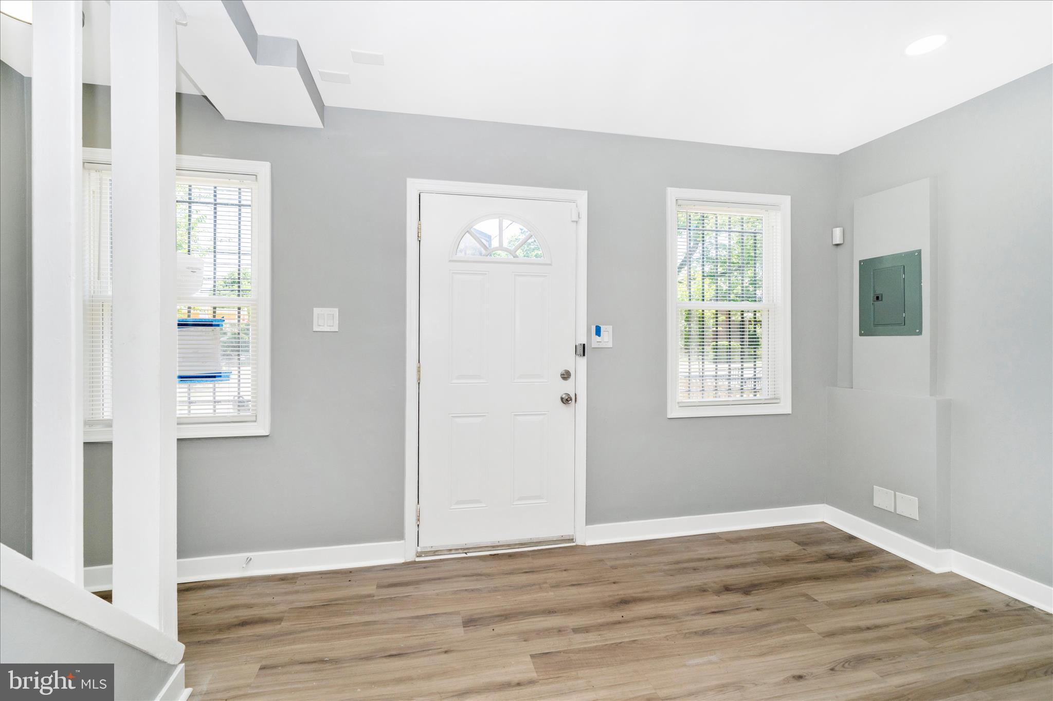 5027 Benning Road Southeast Washington, DC 20019 - Photo 5 of 57 an empty room with wooden floor and windows