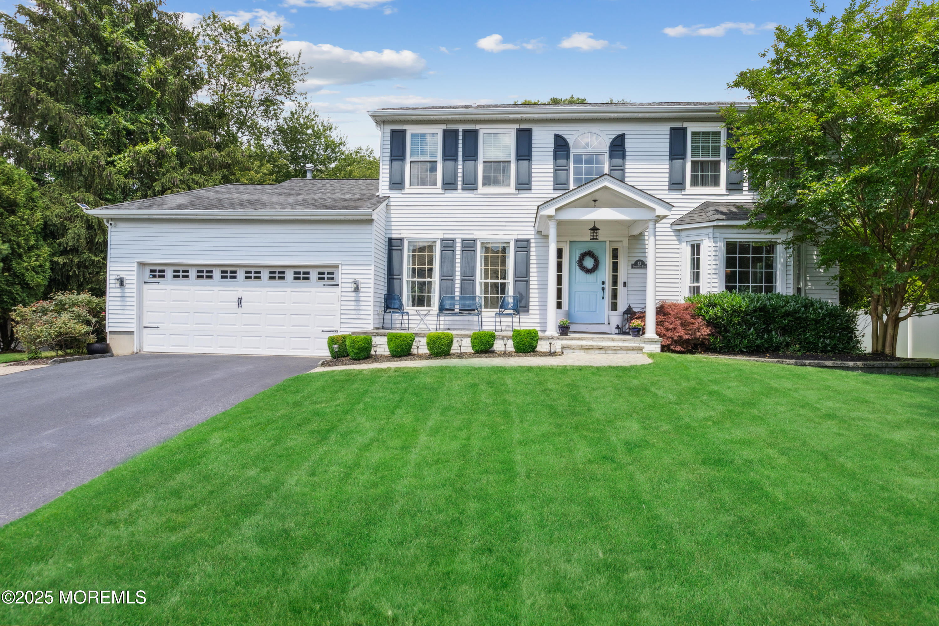 43 Sweet Gum Road Howell, NJ 07731 - Photo 1 of 48 a front view of a house with garden and trees