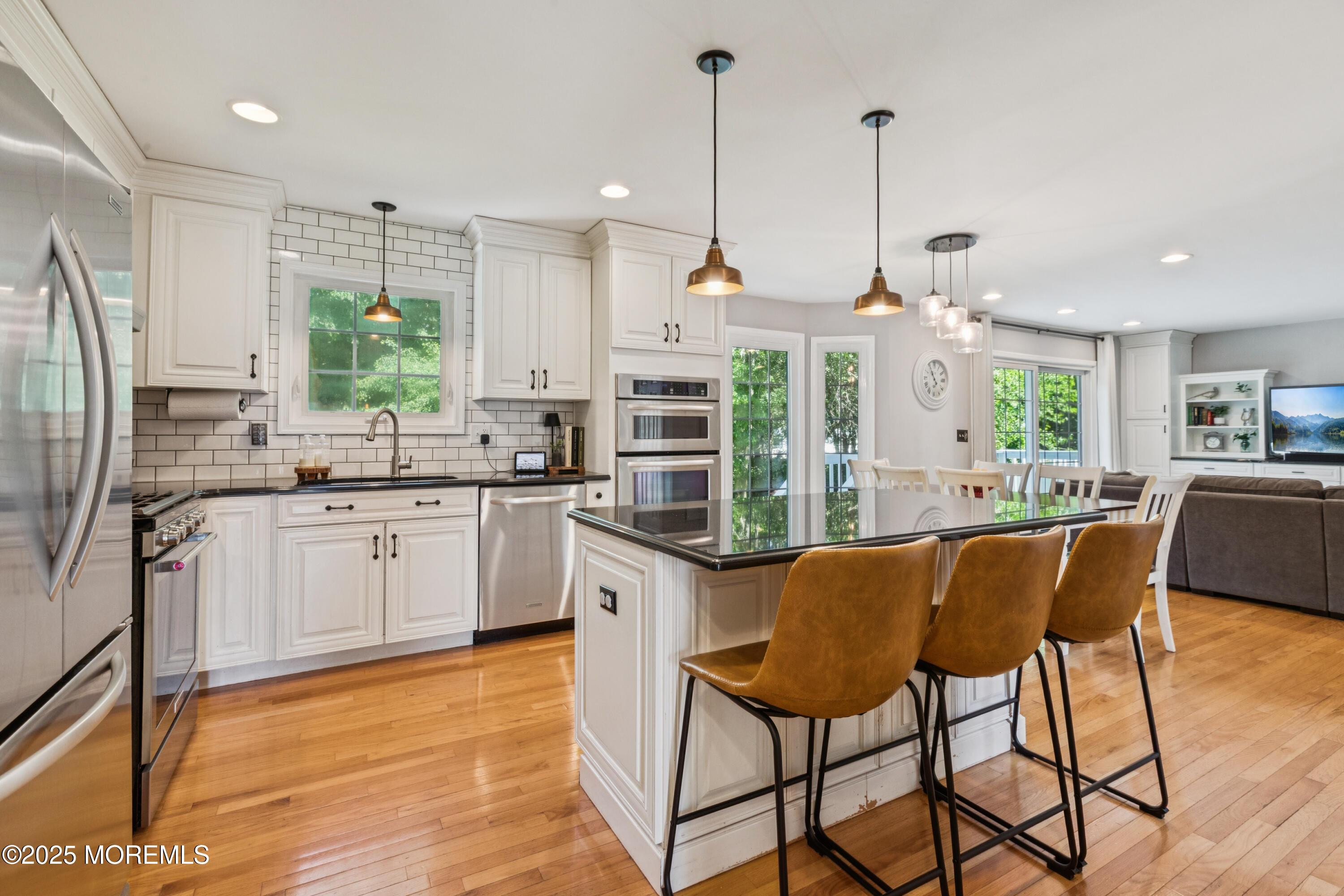 43 Sweet Gum Road Howell, NJ 07731 - Photo 12 of 48 a kitchen with stainless steel appliances kitchen island granite countertop a stove a sink dishwasher a refrigerator with a dining table and chairs