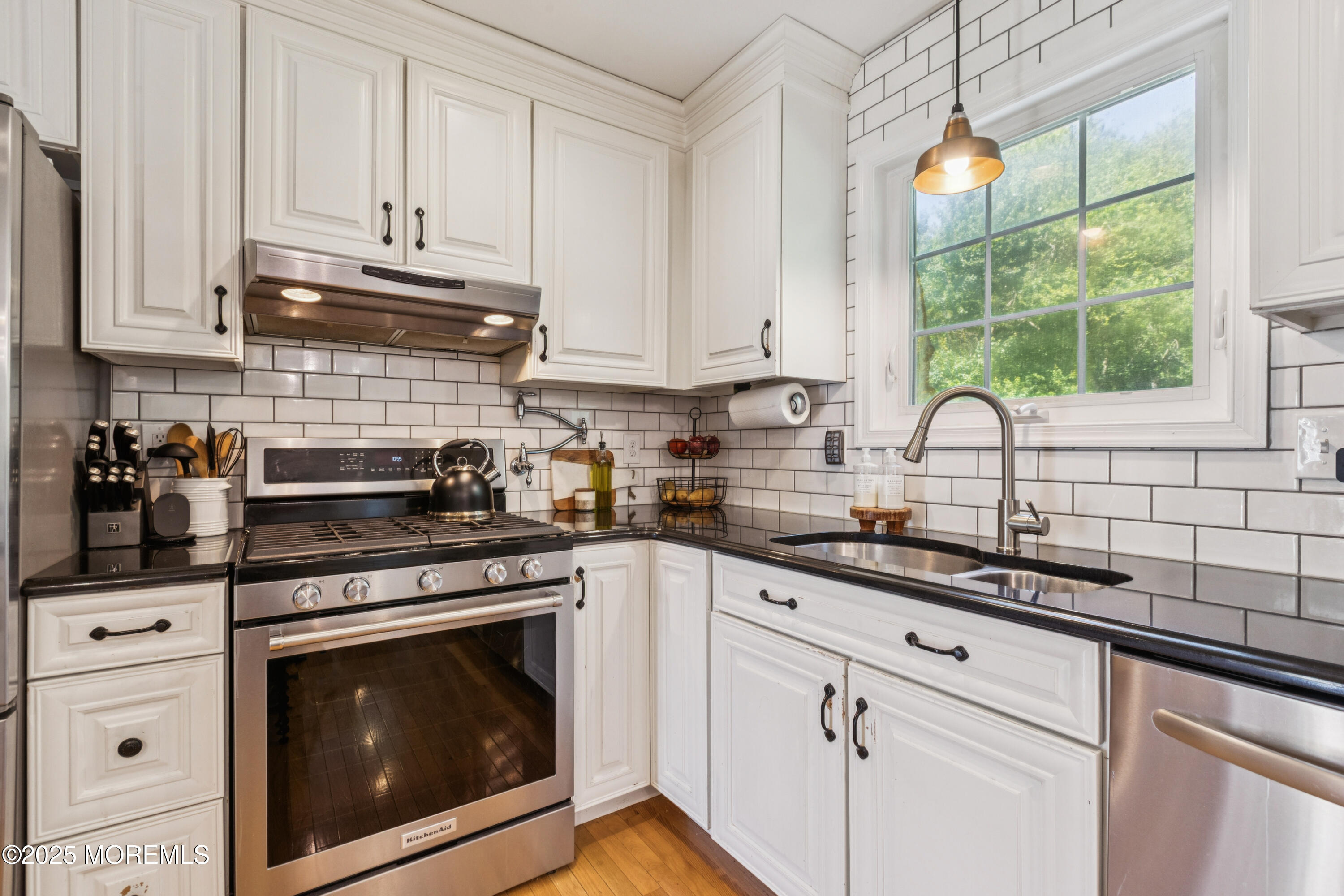 43 Sweet Gum Road Howell, NJ 07731 - Photo 13 of 48 a kitchen with granite countertop white cabinets and white appliances