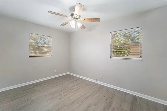 a view of room with window and wooden floor