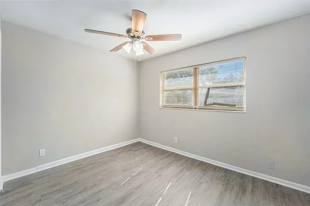 a view of a room that has a window and wooden floor