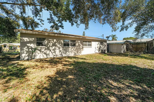 a view of a house with backyard outdoor area and seating area