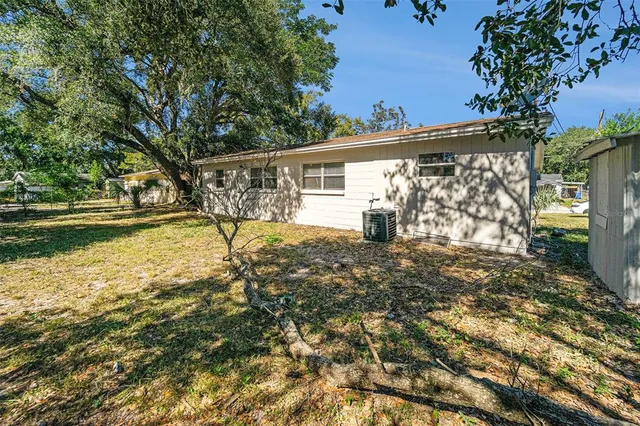 a view of a house with backyard and sitting area