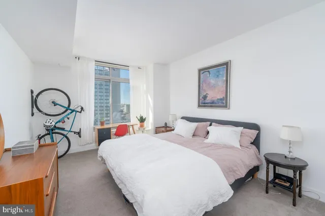 a bedroom with bed and a window