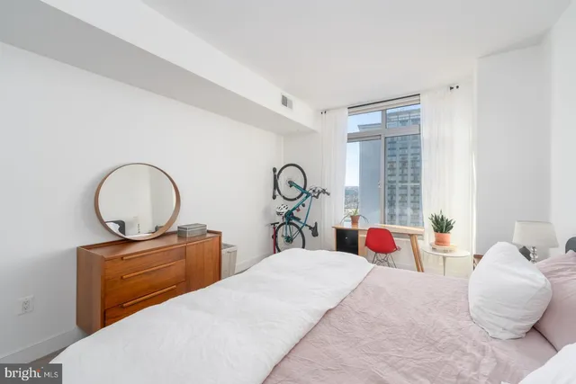 a bedroom with a bed and a couch